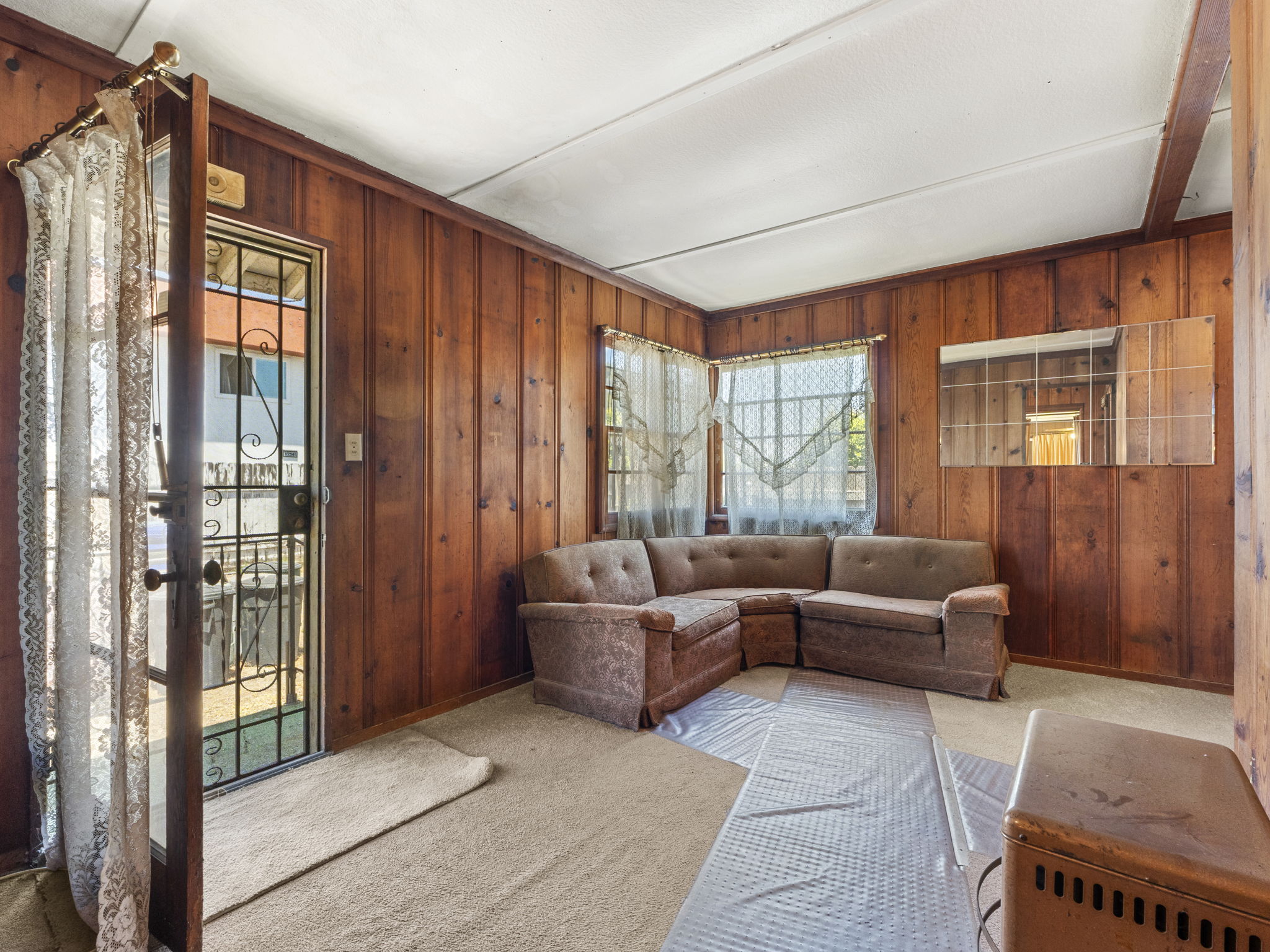 Existing paneled living room with furniture