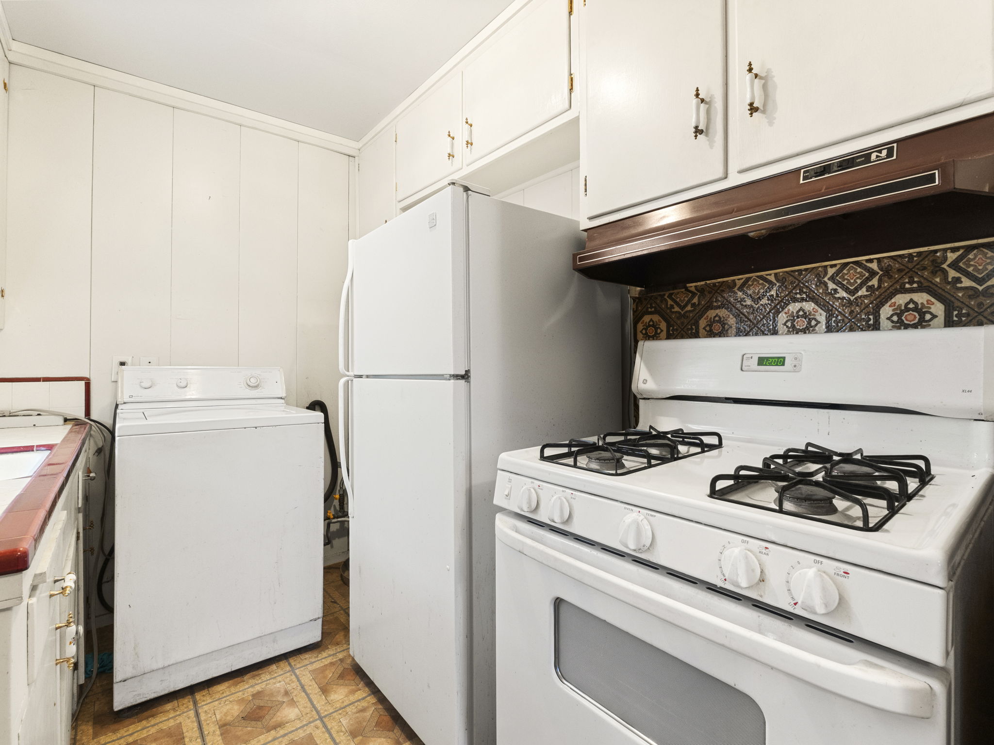 Existing kitchen with washer and white appliances